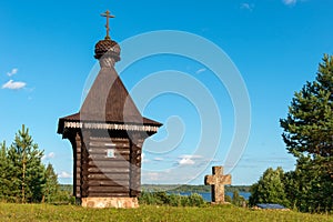 A small chapel and an old cross on a hilltop