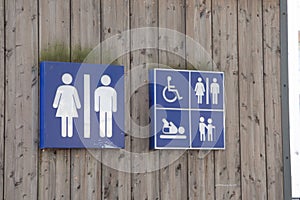 Wc Toilet sign men women  icon on wooden building facade water closets wall entrance