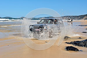 4WD Toyota car driving across a washout in Queensland, Australia.