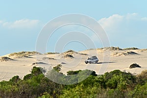 4WD vehicle driving on sand dune near Kalbarri Western Australia