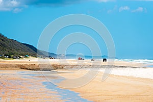 4wd vehicles at Rainbow Beach with coloured sand dunes, QLD, Australia