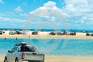 4wd vehicles at Rainbow Beach with coloured sand dunes, QLD, Australia