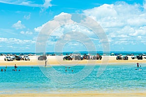 4wd vehicles at Rainbow Beach with coloured sand dunes, QLD, Australia