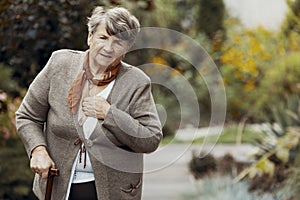 Elderly woman with walking stick during breathlessness attack