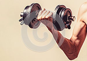 Weak man lift a weight, dumbbells, biceps, muscle, fitness. Skinny guy hold dumbbells up in hands. Thin man in sports