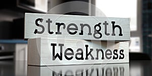 Weakness, strength - words on wooden blocks