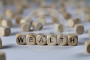 Wealth - cube with letters, sign with wooden cubes