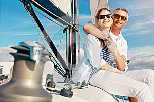 Wealth, rich and couple vacation on a yacht at sea as retirement investment feeling happy, excited and enjoying travel