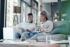 The wealthiest marriage is one with love in it. a young couple going through paperwork at home.