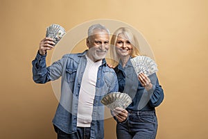 Wealthy rich happy elderly man and woman with cash money