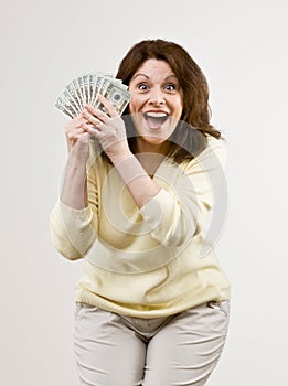 Wealthy woman holding group of twenty dollar bi