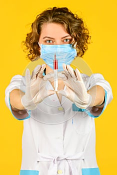 Wear respirator mask. medicine vial dose injection. medical injection against coronavirus. woman nurse with stethoscope