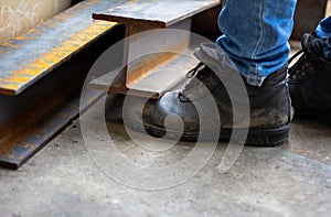 Wear safety shoes to ensure safety at work. construction workers wear safety shoes.