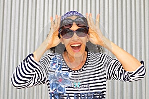 Happy woman with two Pairs Sunglasses