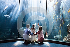 Wear view of family looking at fish tank