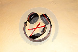 Wearable headphones and sunglasses with combination red color isolated on light orange background