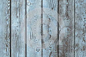 Wearhered wood boards background of brown planks with partially erased light blue paint