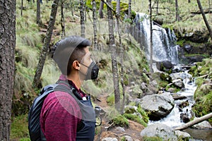 wearing a mask ,Man looking at the Waterfall in Izta-Popo Zoquiapan National Park