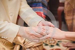 Wearing a wedding ring at a Thai wedding ceremony