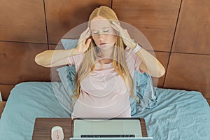 Weary pregnant woman, tired of working from home, navigates the challenges of balancing professional tasks with