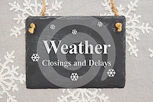 Weather closings and delays message on a chalk sign