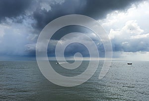 Weather cloudy and rainy on ocean storms and fishing boat on a middle sea wave. Traditional fishing boat on the river.