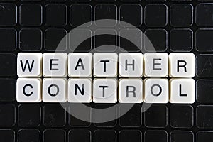 Weather control text word title caption label cover backdrop background. Alphabet letter toy blocks on black reflective background