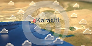 Cloudy weather icons near Karachi city on the map, weather forecast related 3D rendering