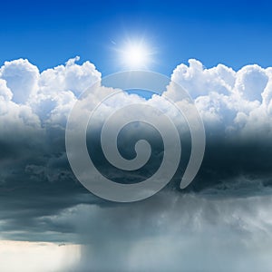 Weather forecast concept image: variety weather conditions, bright sun in blue sky, dark clouds with heavy rain