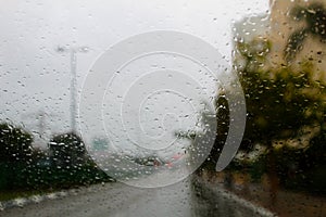 Weather in Israel: Winter rains. Abstract view to rainy road city through the car windscreen