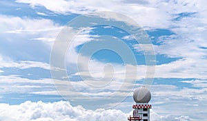 Weather observations radar dome station against blue sky and white fluffy clouds. Aeronautical meteorological observations station