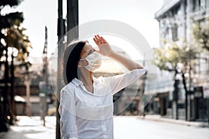 Weather, Pollution and Ecology Issue Concept. Young Woman Wearing Protection Mask against Roadside