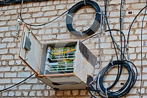 Weather sealed box with fiber optic switch placed on the apartment building wall