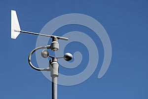 Weather station instruments against blue sky background