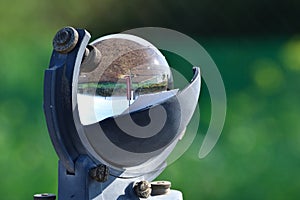 Weather station and the sun in a blue sky reflected in the glass sphere of a beautiful heliograph o photo