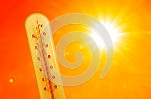 Weather thermometer with high temperature outdoors on hot sunny day. Heat stroke warning