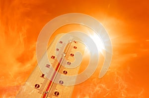 Weather thermometer with high temperature outdoors on hot sunny day. Heat stroke warning