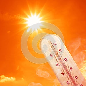 Weather thermometer with high temperature outdoors on hot sunny day. Heat stroke warning