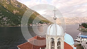 Weather vane-cross on the tower of the Church of Our Lady on the Rocks. Montenegro