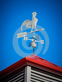 Weather vane on red roof