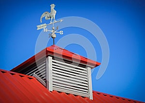 Weather vane on red roof