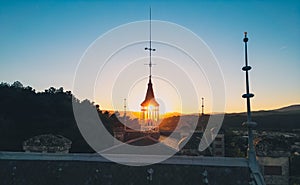 Weather vane on the roof of the castle at sunset