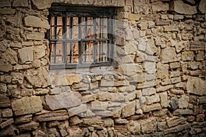 Weathered Abandoned Building Exterior with Damaged Walls and Old Windows. Place of imprisonment, Prison with the old window