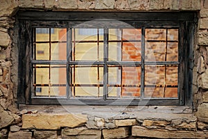 Weathered Abandoned Building Exterior with Damaged Walls and Old Windows. Place of imprisonment, Prison with the old window