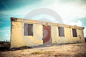 Weathered abandoned building with peeling yellow paint