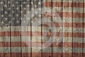 Weathered barn siding with faded painted american flag