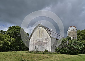 Weathered Barn and Silo under a cloudy sky