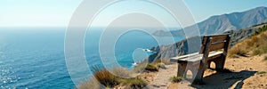 Weathered bench perched on coastal clifftop; boundless sea view, shadow, clifftop, holiday