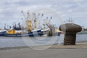 Weathered bollard in a harbor in the north of the Netherlands