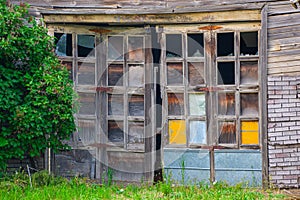 Weathered, broken doors on an old abandoned building in Eastern Washington